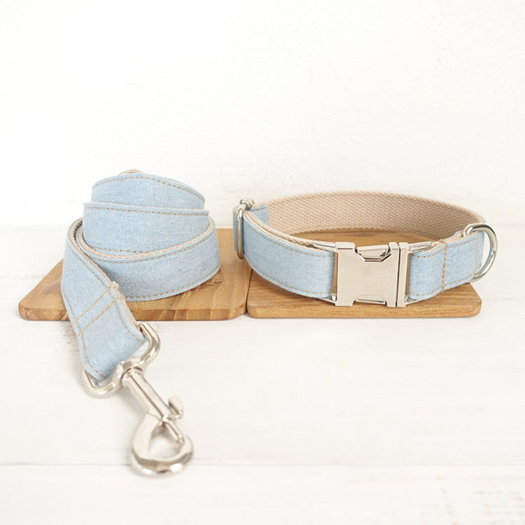 Light blue denim dog collar and leash set with silver buckle and snap hook displayed on wooden blocks