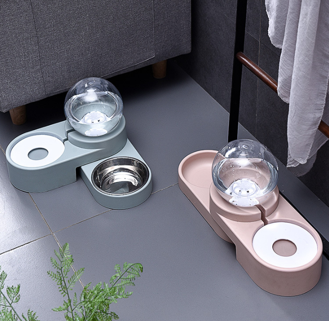 Blue and pink automatic pet water and food bowl sets with clear globe water reservoirs side by side