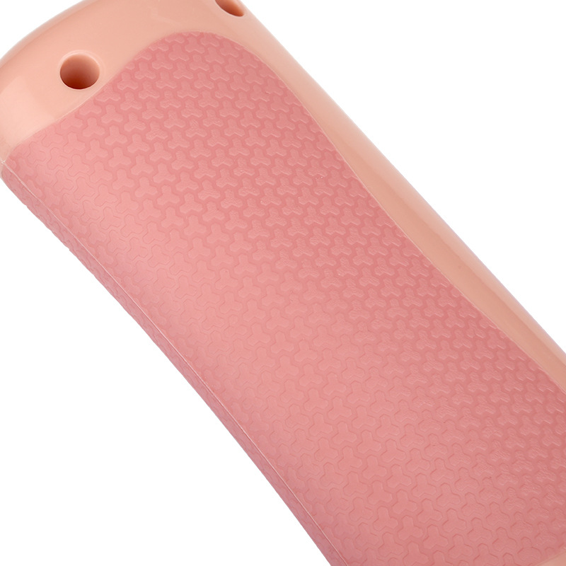 Close-up of a pink electronic device with textured surface