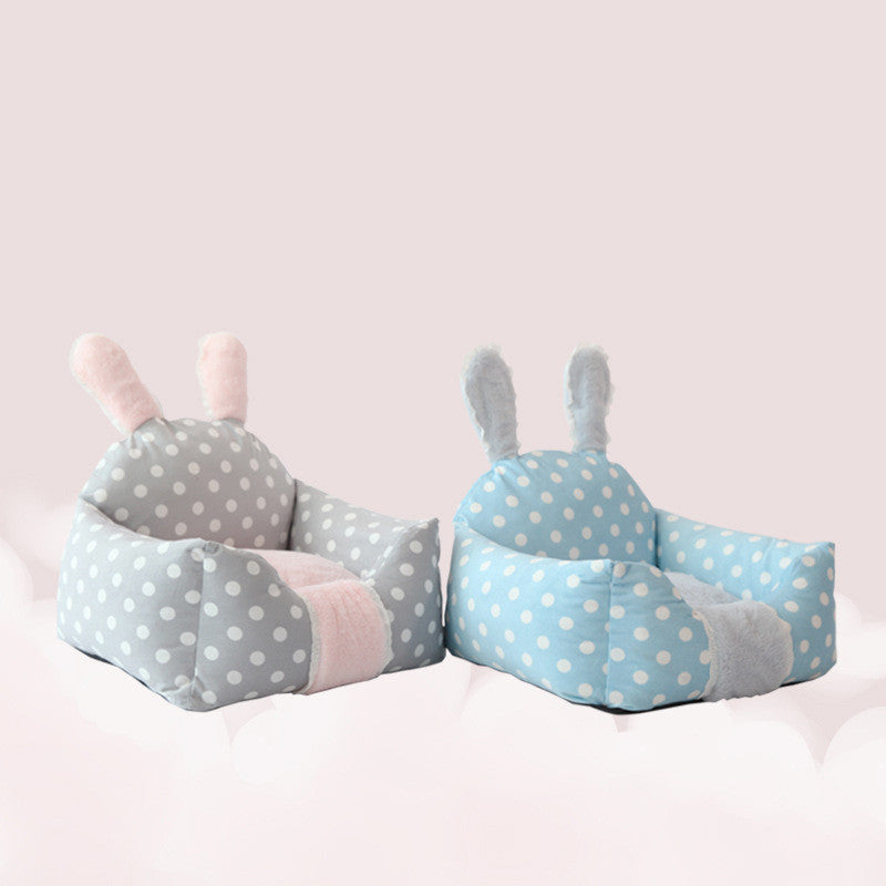 Two polka dot bunny-shaped cushions on a light pink background