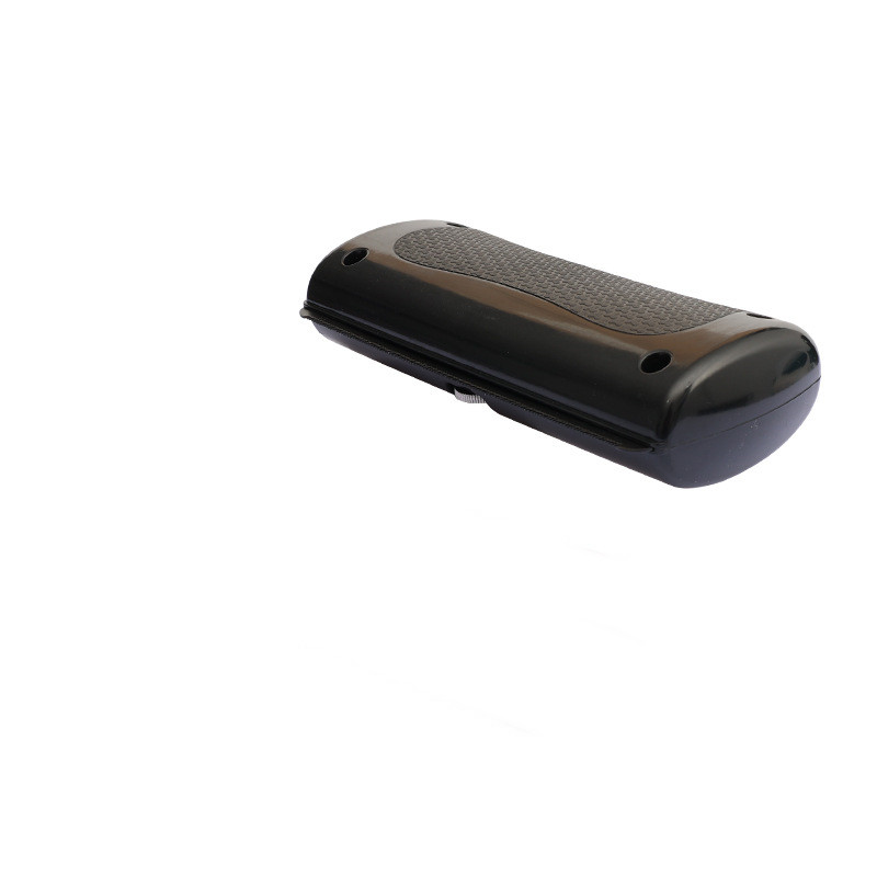 Black rectangular object with textured surface on a white background