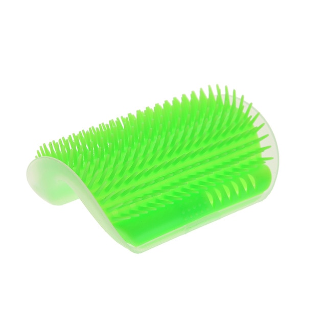 Green pet grooming brush on a white background