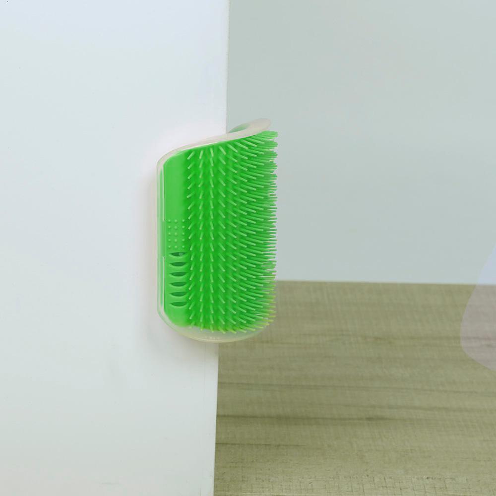 Green pet grooming brush on a white background