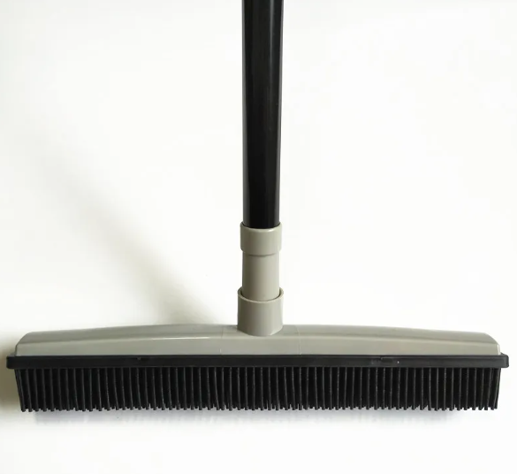 Gray broom with a black handle on a white background